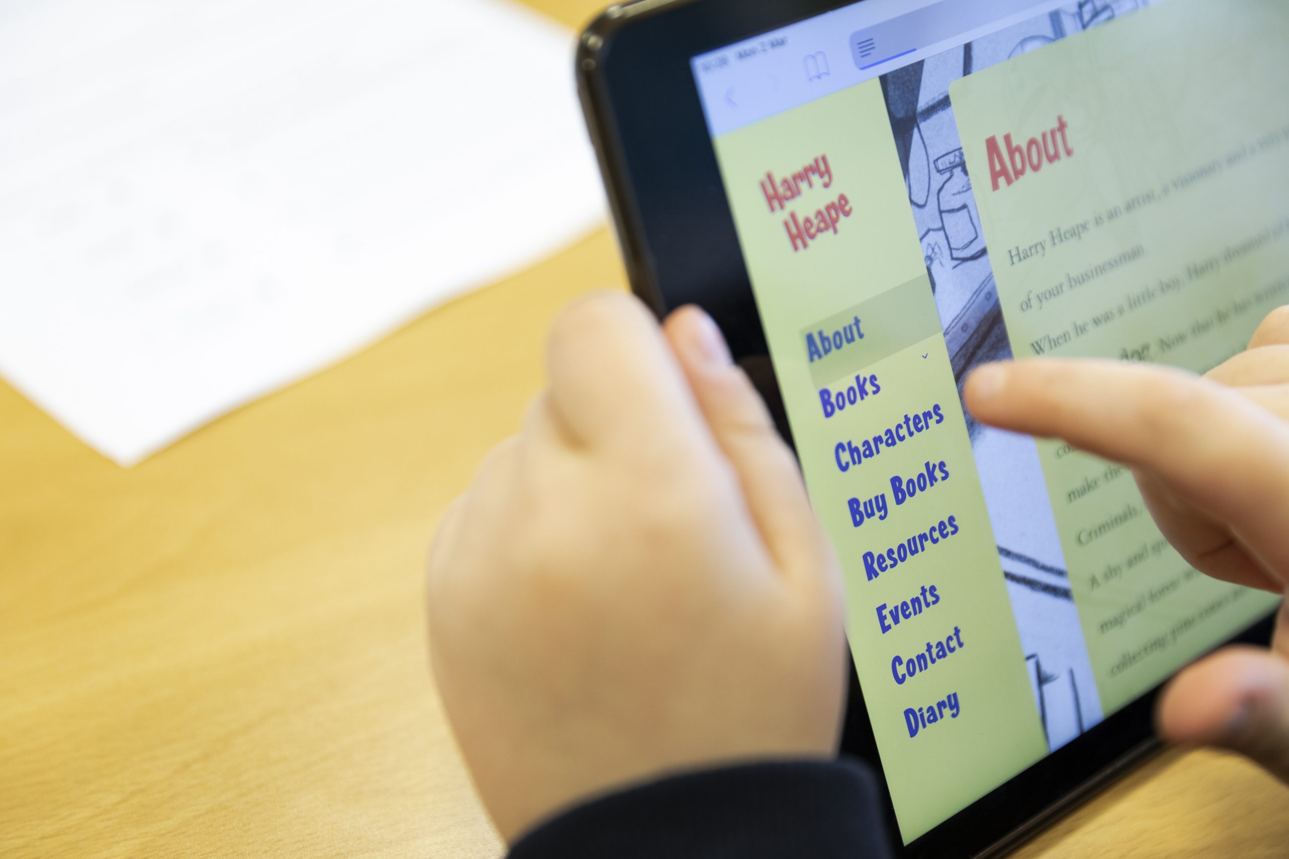 A school student looks up a book website using an iPad