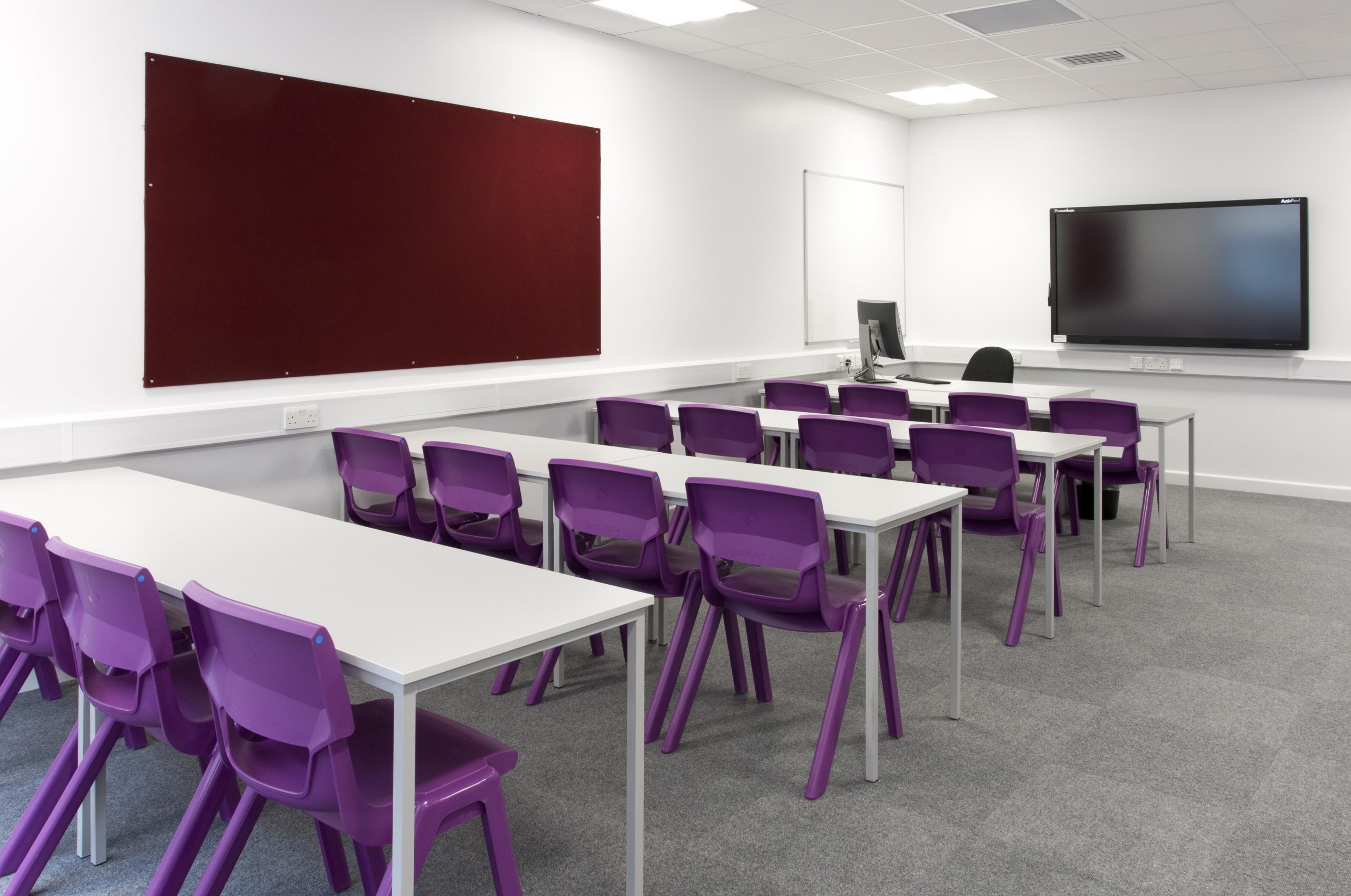 A classroom with desks and chairs