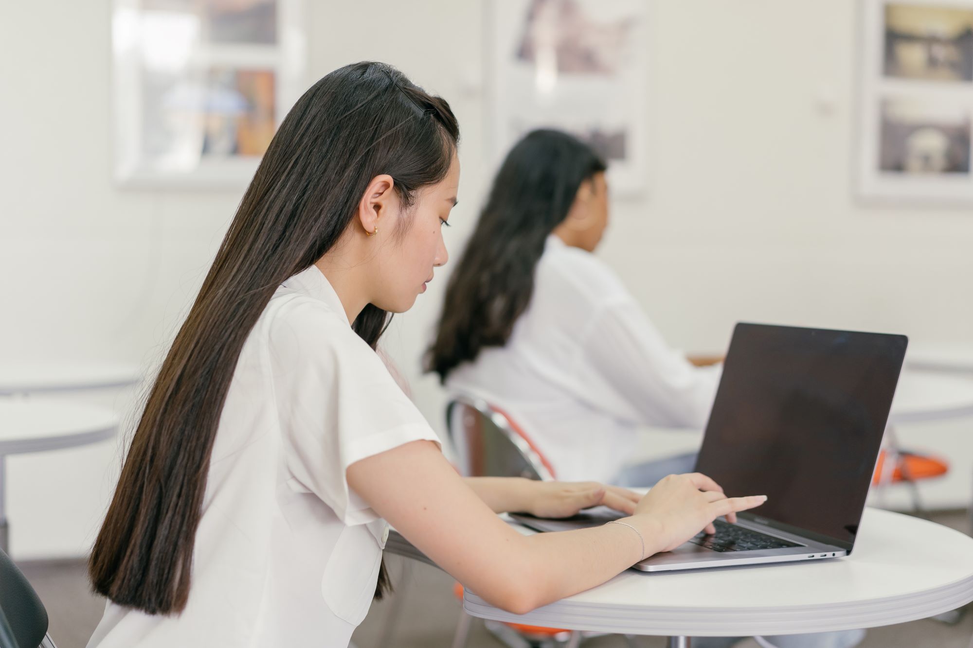 A student uses a laptop in a classroom